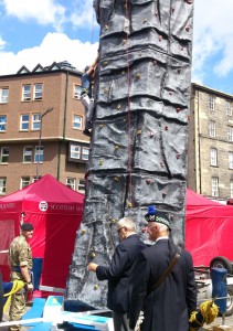 boy climbs rock wall